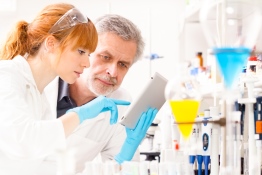 The image shows three scientists in the laboratory.